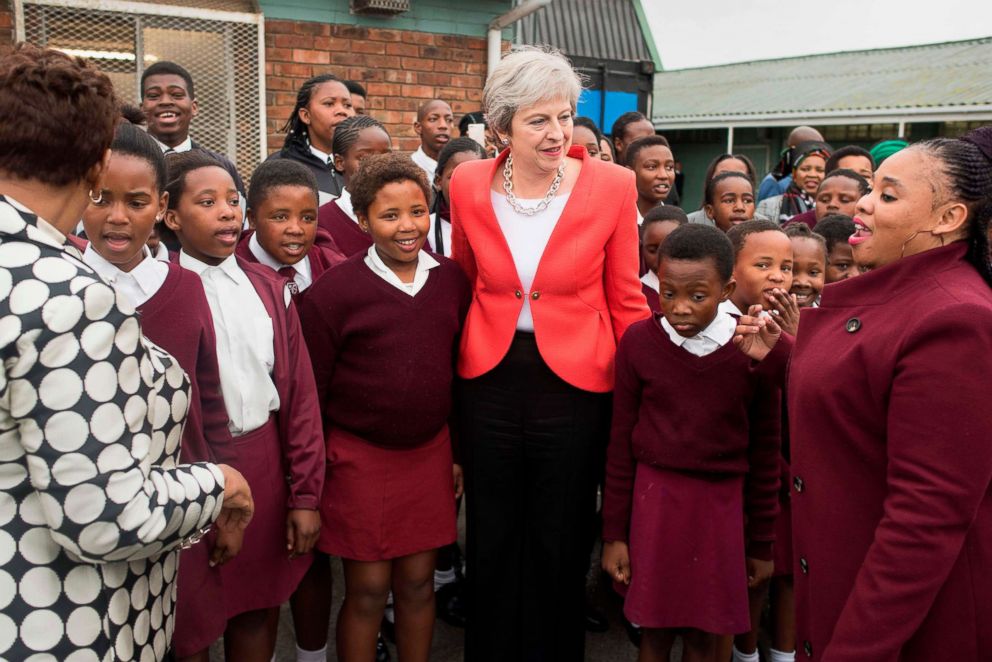 PHOTO: Britain's Prime Minister Theresa May poses with school children during a visit to the ID Mkhize Secondary School in Gugulethu, as part of a working visit to South Africa, Aug. 28, 2018, near Cape Town.