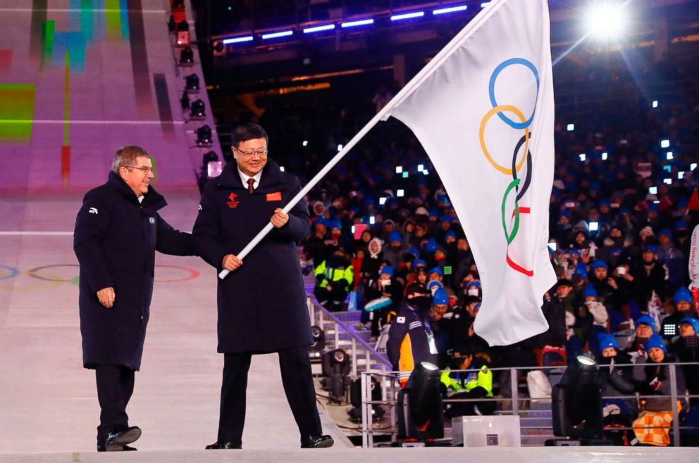 PHOTO: The President of the International Olympic Committee Thomas Bach (L) passes on the pole during the handover ceremony of the Olympic flag to the Mayor of Beijing Chen Jining at the Pyeongchang Stadium, Feb. 25, 2018 in South Korea.