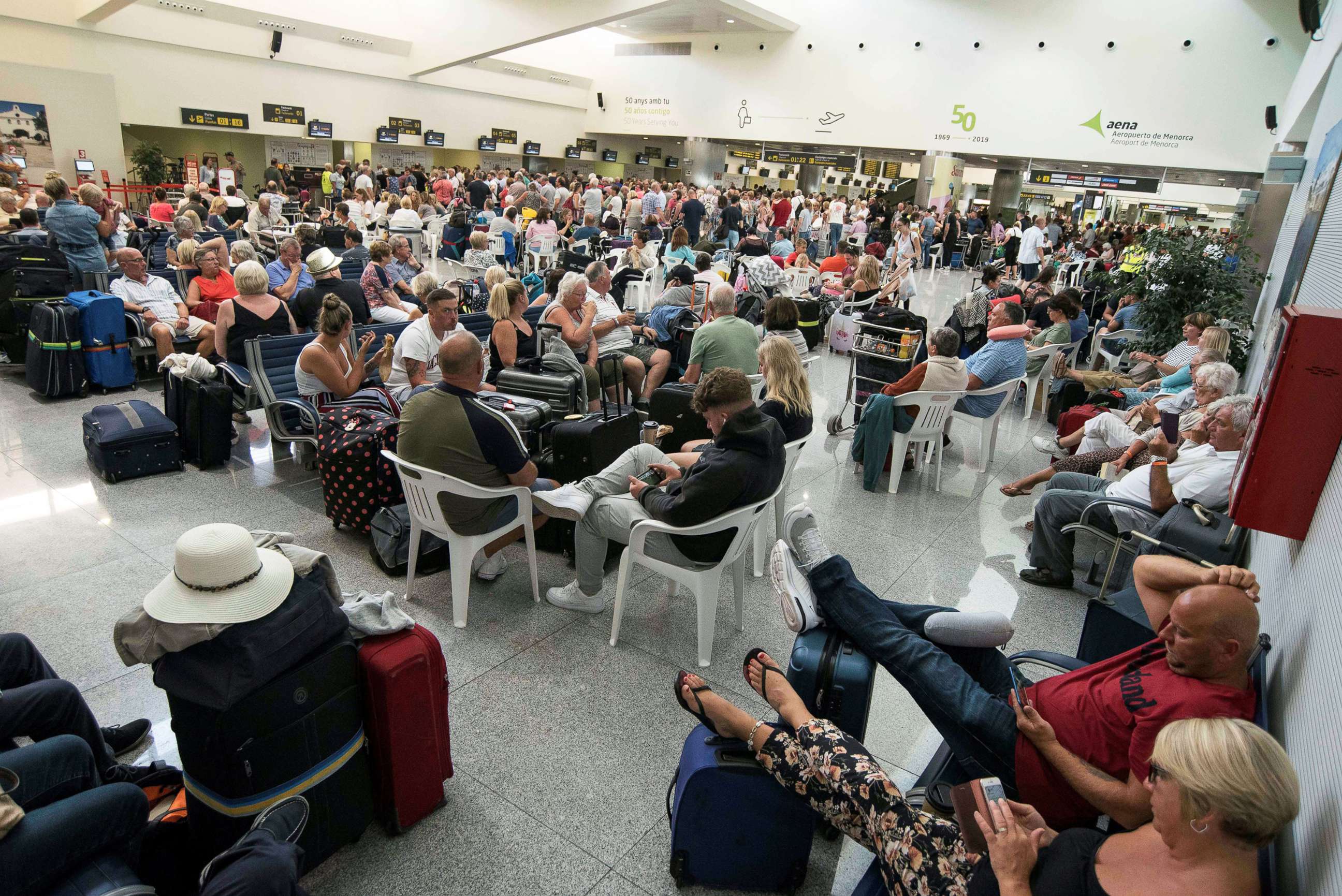 PHOTO: Several passengers wait at the airport in Menorca island, eastern Spain, Sept.23, 2019.
