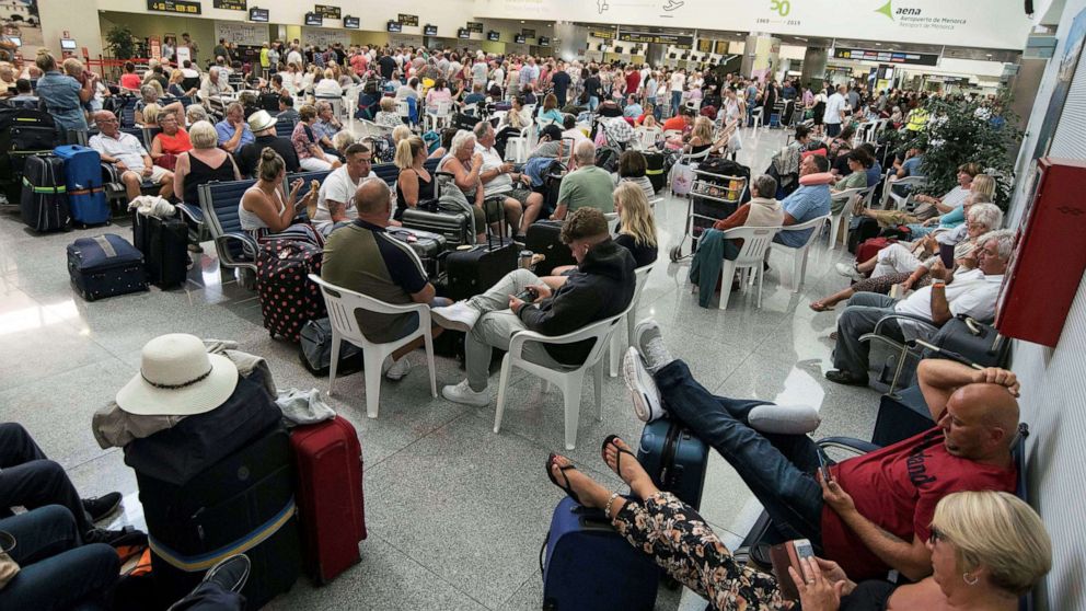 PHOTO: Several passengers wait at the airport in Menorca island, eastern Spain, Sept.23, 2019.