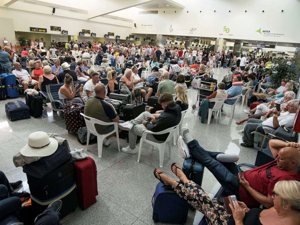 PHOTO: Several passengers wait at the airport in Menorca island, eastern Spain, Sept.23, 2019.