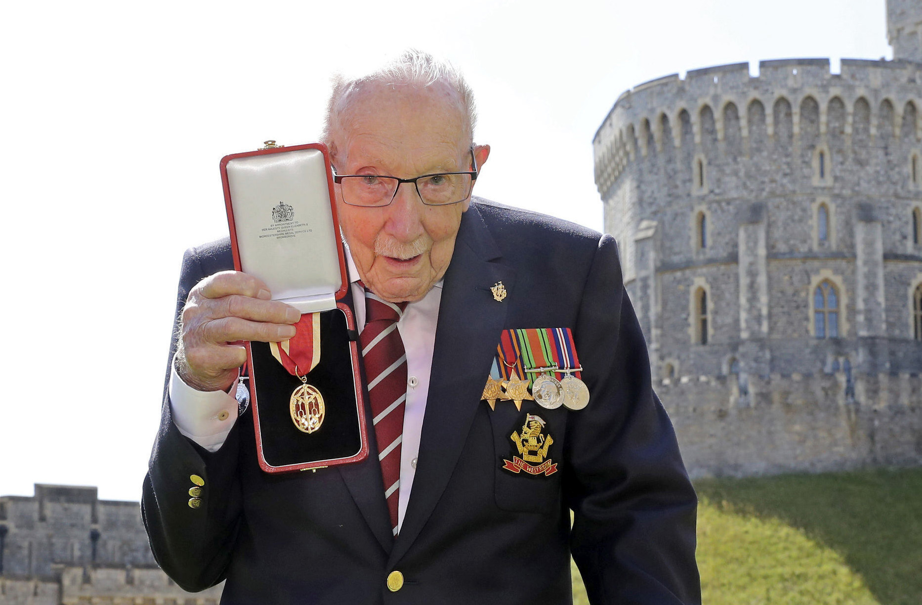 PHOTO: Captain Sir Thomas Moore poses for the media after receiving his knighthood from Britain's Queen Elizabeth, during a ceremony at Windsor Castle in Windsor, England.