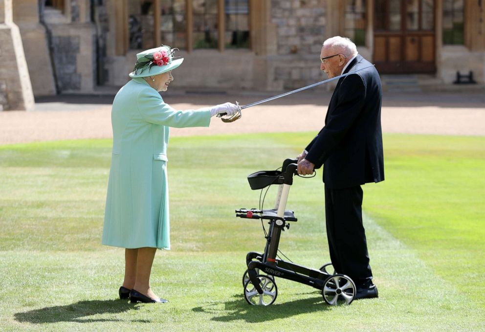 PHOTO: Queen Elizabeth II awards Captain Sir Thomas Moore with the insignia of Knight Bachelor at Windsor Castle on July 17, 2020 in Windsor, England.