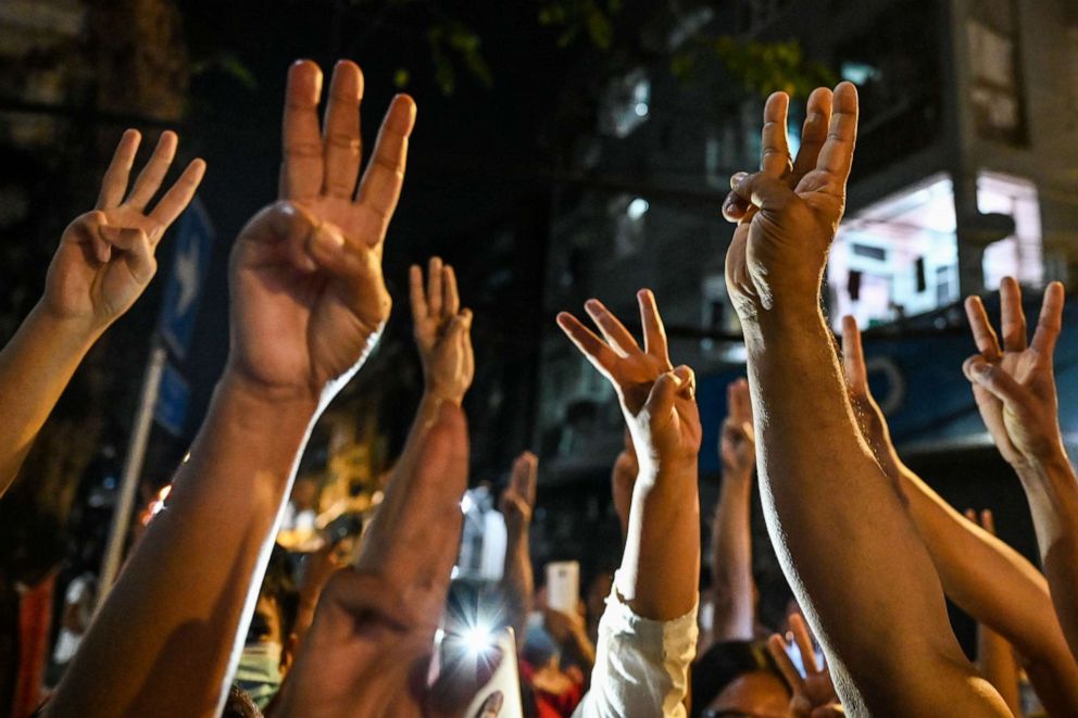 PHOTO: TOPSHOT - People give a three-finger salute after calls for protest went out on social media in Yangon on February 3, 2021, as Myanmar's ousted leader Aung San Suu Kyi was formally charged on Wednesday. two days after she was detained in a coup. 