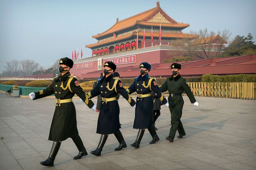 PHOTO: Security officials wear face masks as they march in formation near Tiananmen Gate adjacent to Tiananmen Square in Beijing, Jan. 27, 2020, during the novel coronavirus outbreak.