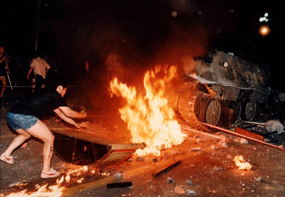 PHOTO: A student protester puts barricades in the path of an already burning armored personnel carrier that rammed through student lines during an army attack on anti-government demonstrators in Beijing's Tiananmen Square, June 4, 1989.