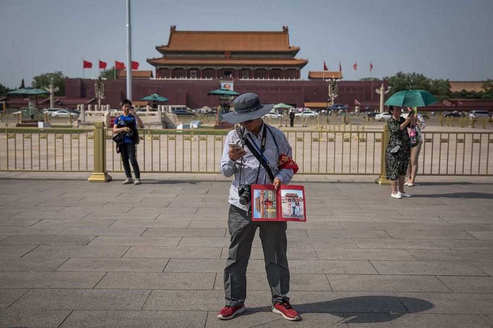 PHOTO: A Chinese photographer offers to photograph tourists on the Tiananmen Square in Beijing, China, May 16, 2019.