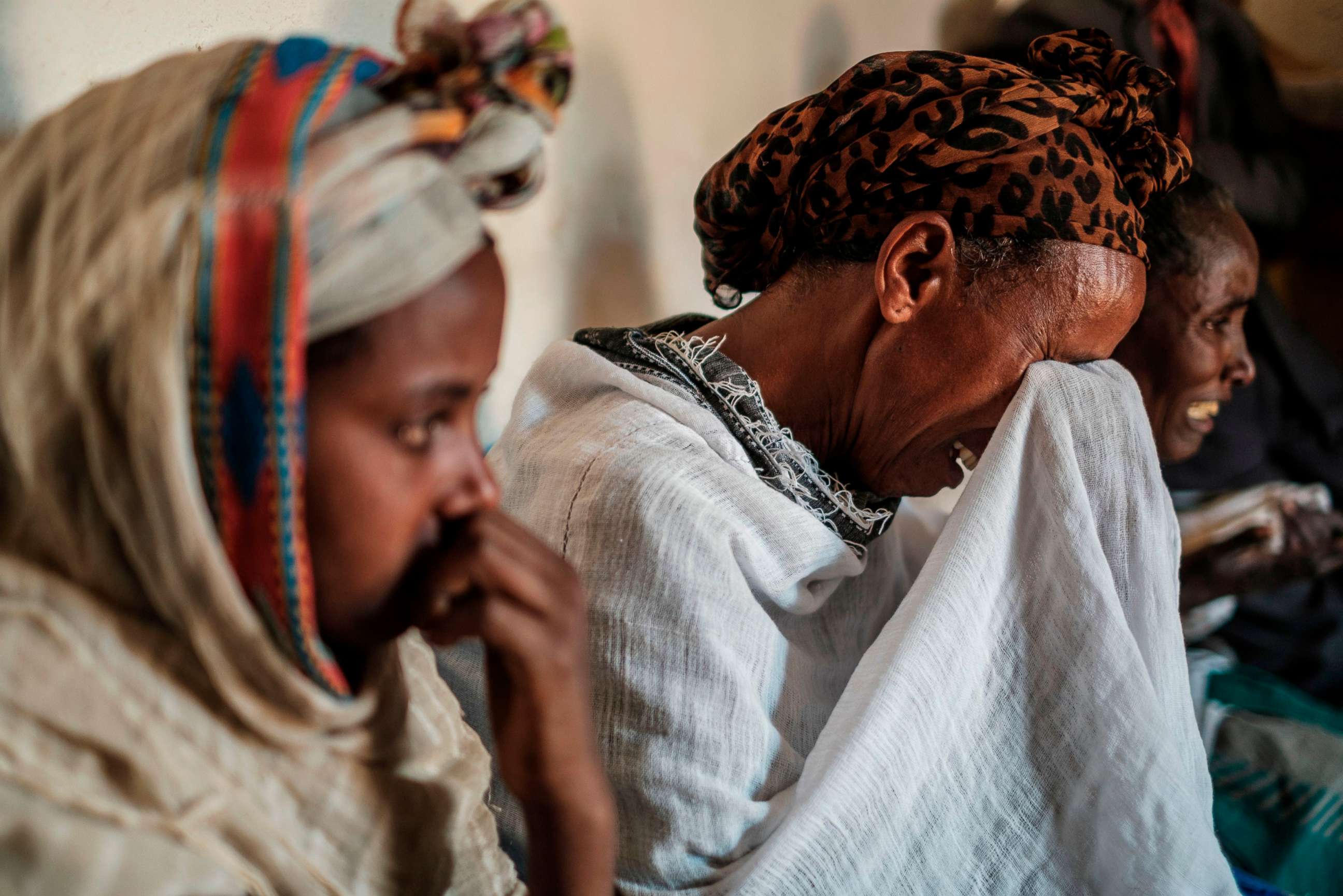 PHOTO: People mourn the victims of a massacre allegedly perpetrated by Eritrean Soldiers, at the house of Beyenesh Tekleyohannes, in the village of Dengolat, North of Mekele, the capital of Tigray on Feb. 26, 2021.