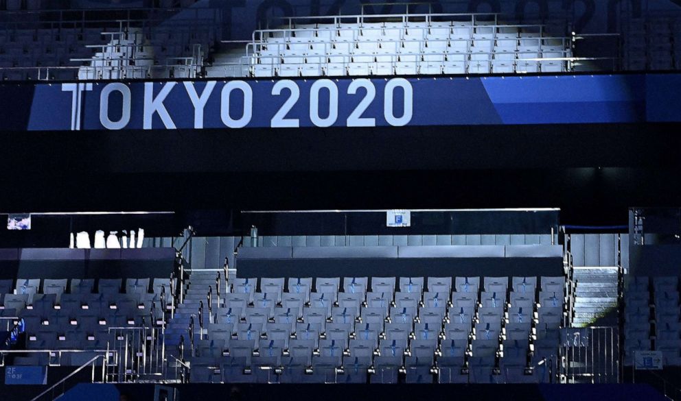 PHOTO: A spotlight highlights empty seats in the stadium ahead of the women's 3m springboard diving final event during the Tokyo 2020 Olympic Games at the Tokyo Aquatics Centre in Tokyo on August 1, 2021. \