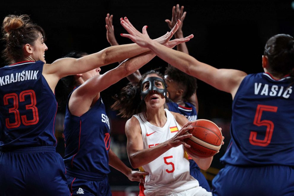 PHOTO: Spain's Cristina Ouvina runs with the ball past Serbia's Tina Krajisnik and Sonja Vasic in the women's preliminary match between Spain and Serbia during the Tokyo 2020 Olympic Games at the Saitama Super Arena in Saitama on July 29, 2021.