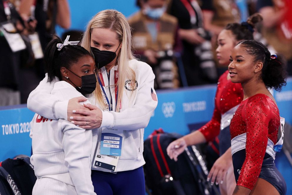 PHOTO: Simone Biles of Team United States is embraced by coach Cecile Landi during the Women's Team Final on day four of the Tokyo 2020 Olympic Games at Ariake Gymnastics Centre on July 27, 2021 in Tokyo, Japan.