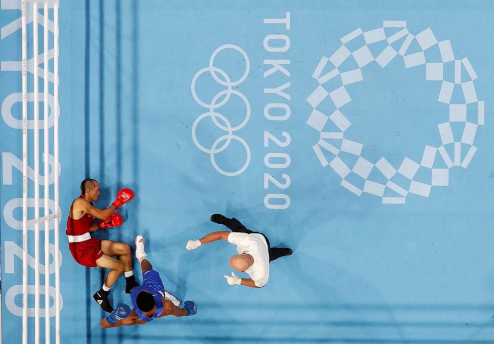 PHOTO: Eldric Sella Rodriguez of the Refugee Olympic Team lies on the ground after being knocked down during his fight against Euri Cedeno Martinez of the Dominican Republic on July, 26, 2021, in Tokyo.