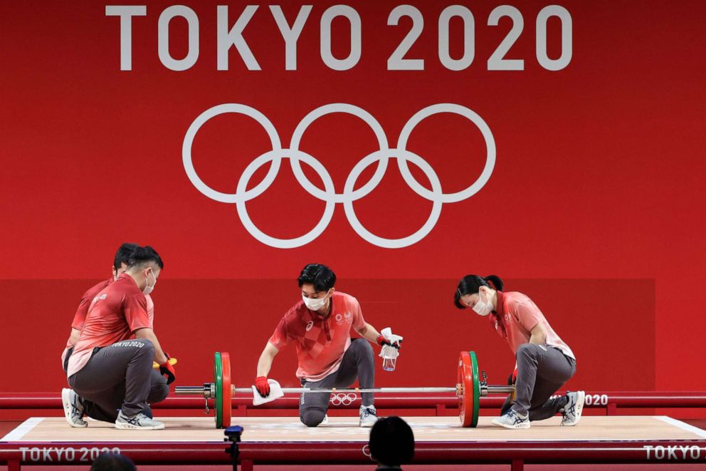 PHOTO: Officials sanitize the weights during Women's 59kg Group during the Weightlifting events of the Tokyo 2020 Olympic Games at the Tokyo International Forum on July 27, 2021 in Tokyo.
Olympic Games 2020 Weightlifting, Tokyo, Japan - 27 Jul 2021
