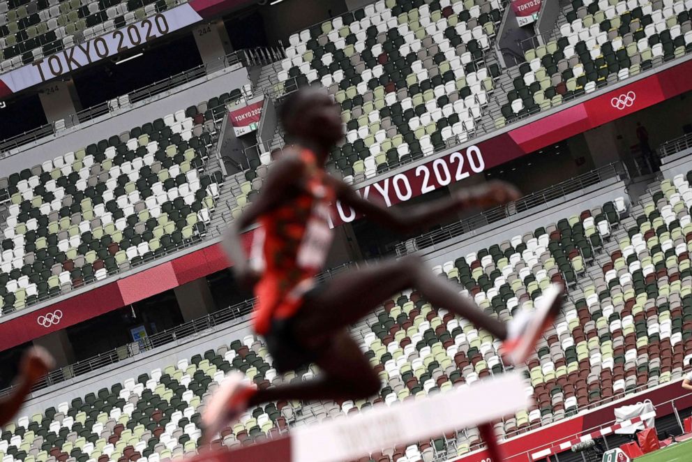 PHOTO: A picture shows empty seats in the stands as athletes compete in the men's 3000m steeplechase heats during the Tokyo 2020 Olympic Games at the Olympic Stadium in Tokyo on July 30, 2021.