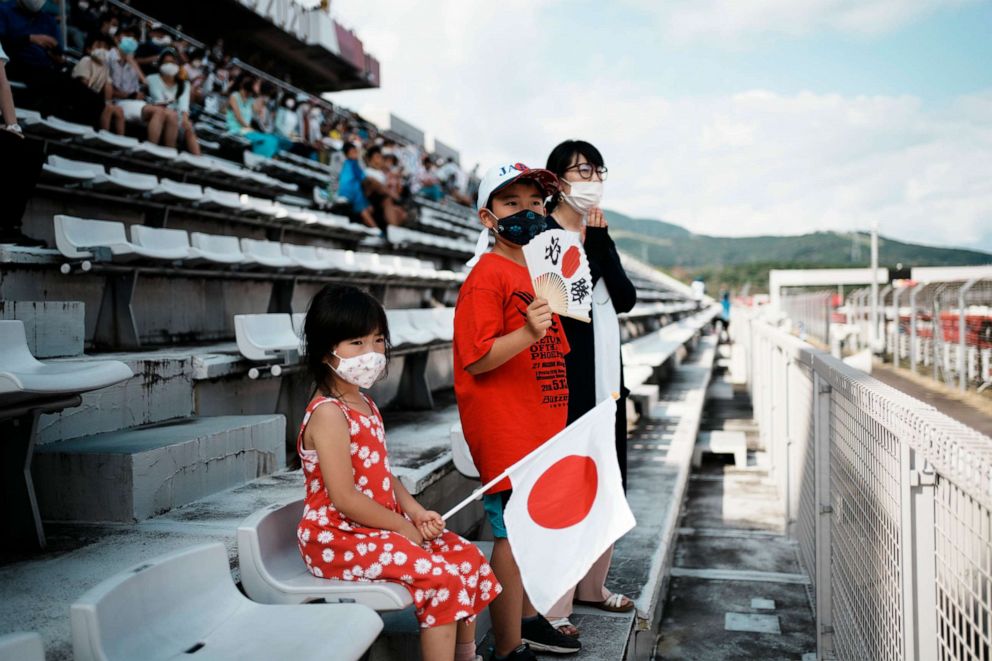 PHOTO: Limited numbers of fans watch in the Fuji International Speedway during the men's cycling road race at the 2020 Summer Olympics, Saturday, July 24, 2021, in Oyama, Japan.