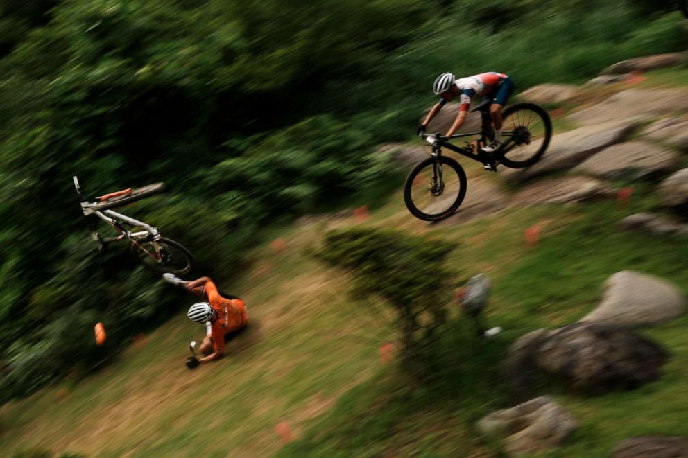 PHOTO: Mathieu van der Poel of the Netherlands tumbles on a downhill during the men's cross country mountain bike competition at the 2020 Summer Olympics, Monday, July 26, 2021, in Izu, Japan.