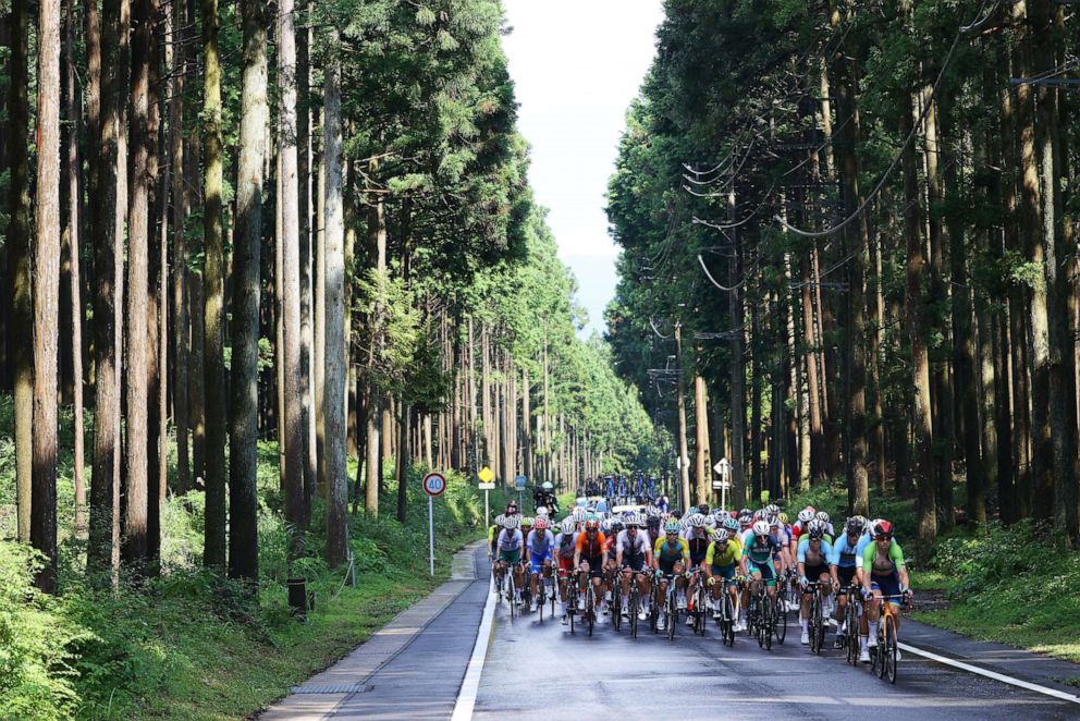 PHOTO: Mauri Vansevenant of Team Belgium & Jan Tratnik of Team Slovenia leads the peloton passes through a forest during the Men's road race at the Fuji International Speedway on day one of the Tokyo 2020 Olympic Games.