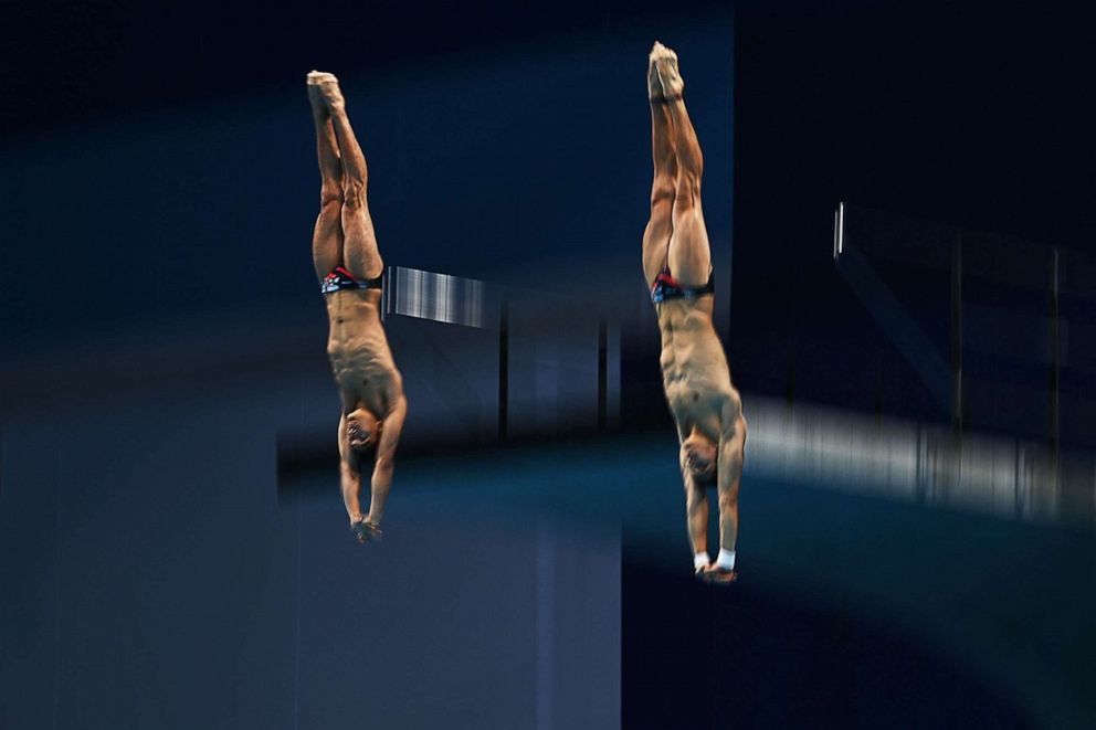PHOTO: Mexico's Jose Balleza Isaias and Mexico's Kevin Berlin Reyes compete in the men's synchronised 10m platform diving final event during the Tokyo 2020 Olympic Games at the Tokyo Aquatics Centre in Tokyo on July 26, 2021.