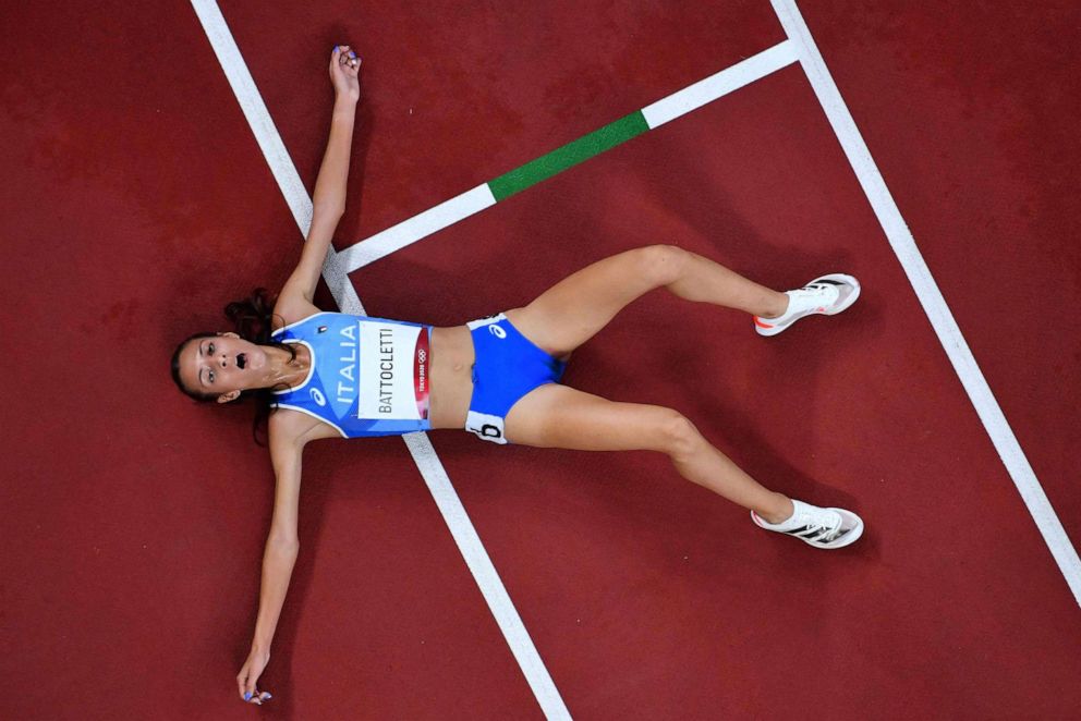 PHOTO: An overview shows Italy's Nadia Battocletti reacting after taking third place in a race of the women's 5000m heats during the Tokyo 2020 Olympic Games at the Olympic Stadium in Tokyo on July 30, 2021.