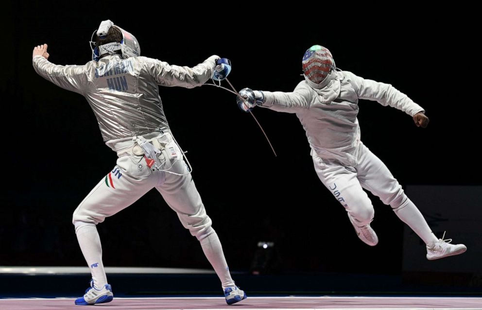 PHOTO: Hungary's Andras Szatmari, left, competes against USA's Daryl Homer in the men's sabre team quarter-final bout during the Tokyo 2020 Olympic Games at the Makuhari Messe Hall in Chiba, Japan, on July 28, 2021.