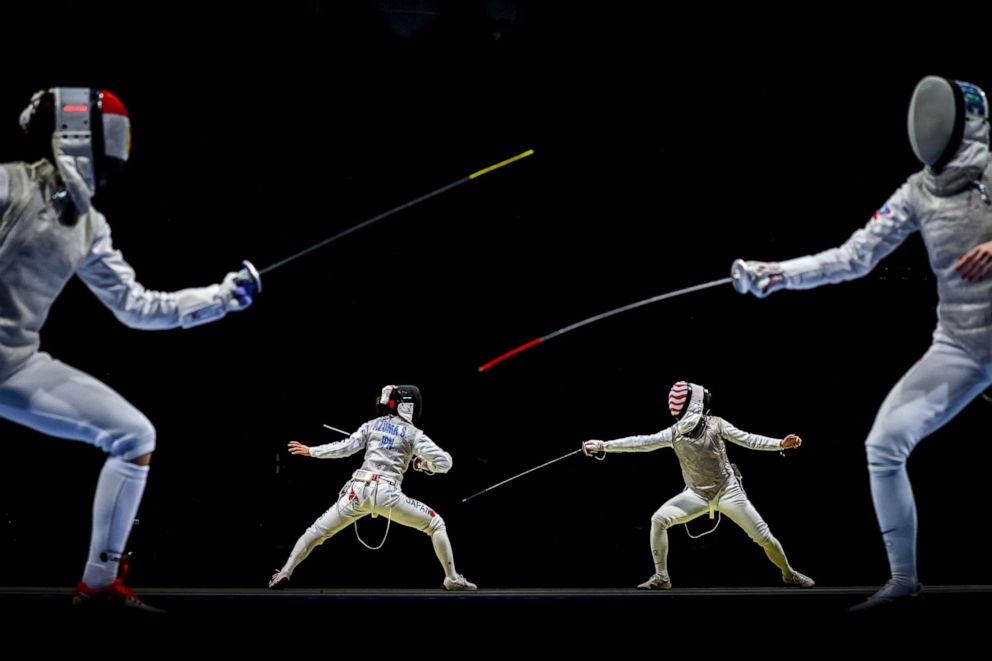 PHOTO: Sera Azuma, center left, of Japan in action against Kiefer Lee of USA as Nora Mohamed, left, of Egypt faces Larisa Korobeynikova of Russian Olympic Committee (ROC) in the Women's Foil team quarterfinals, in Chiba, Japan, July 29, 2021.