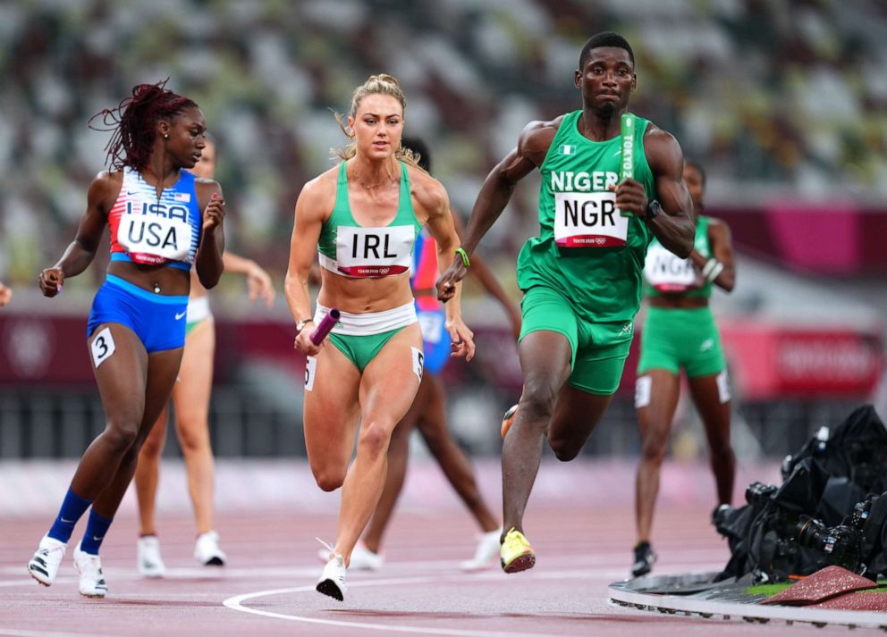 PHOTO: Sophie Becker of Ireland and Samson Nathaniel of Nigeria compete during Heat 1 of the mixed 4x100m relay on July 30, 2021, in Tokyo.