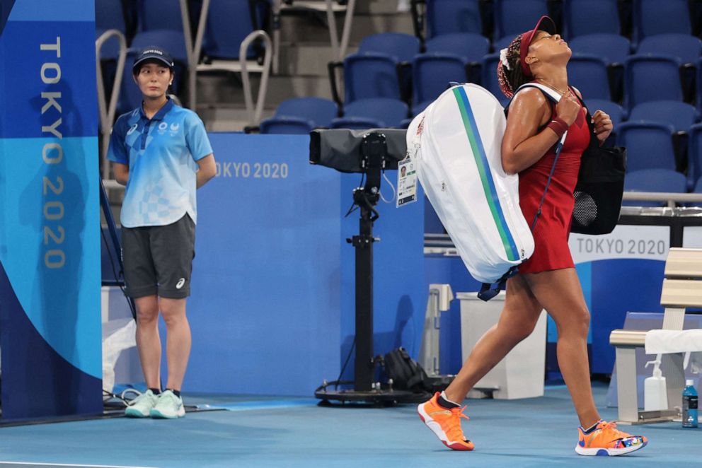 PHOTO: Japan's Naomi Osaka leaves the court after being beaten by Czech Republic's Marketa Vondrousova during their Tokyo 2020 Olympic Games women's singles third round tennis match at the Ariake Tennis Park in Tokyo on July 27, 2021.