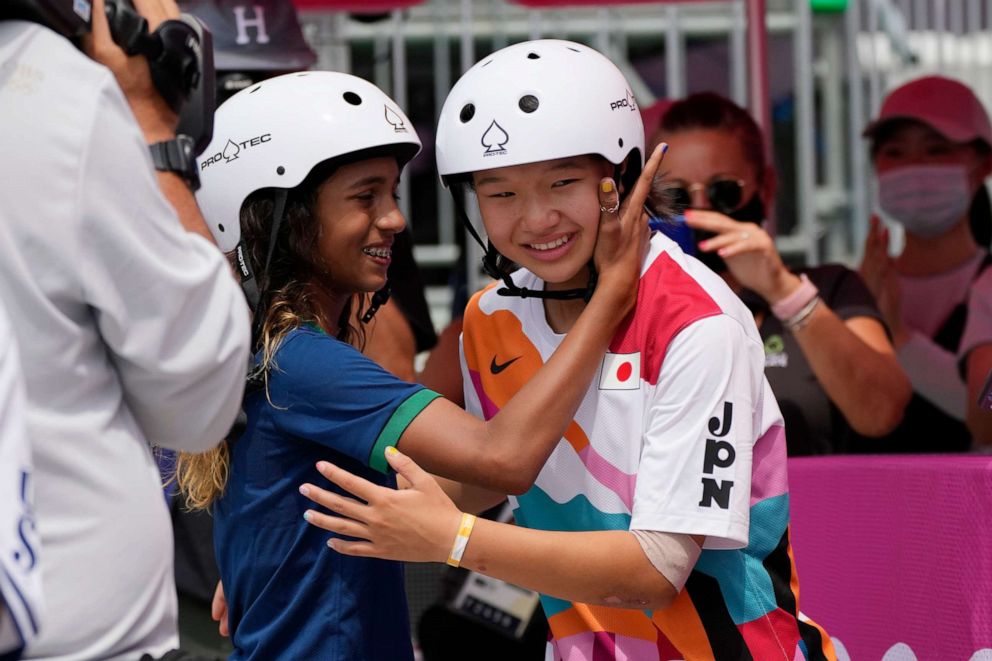 PHOTO: Silver medalist Rayssa Leal of Brazil, left, congratulates gold medal winner Momiji Nishiya of Japan after winning the women's street skateboarding finals at the 2020 Summer Olympics, Monday, July 26, 2021, in Tokyo, Japan.