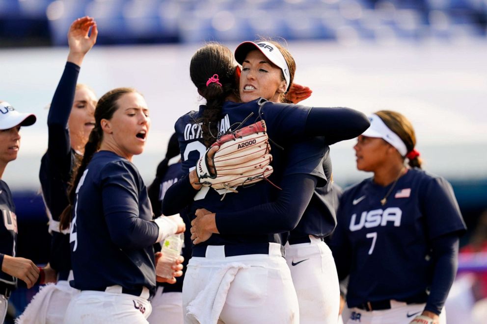 PHOTO: United States' Monica Abbott, center right, and Cat Osterman, center left, embrace defeating Mexico during a softball game at the 2020 Summer Olympics, July 24, 2021, in Yokohama, Japan.