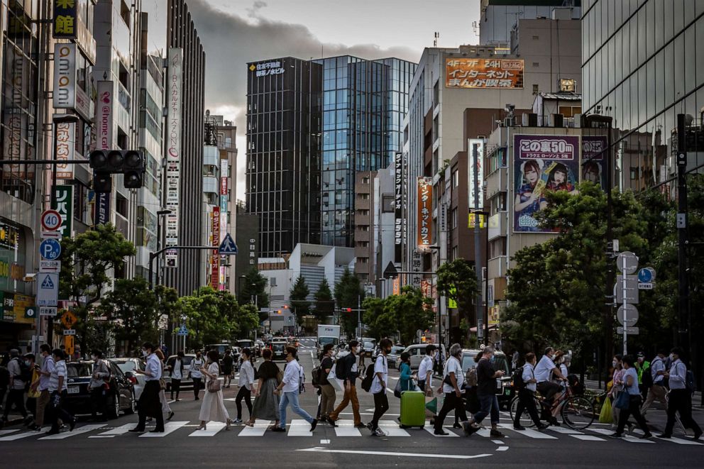 PHOTO: People wearing face masks cross a street on July 29, 2021 in Tokyo, Japan.