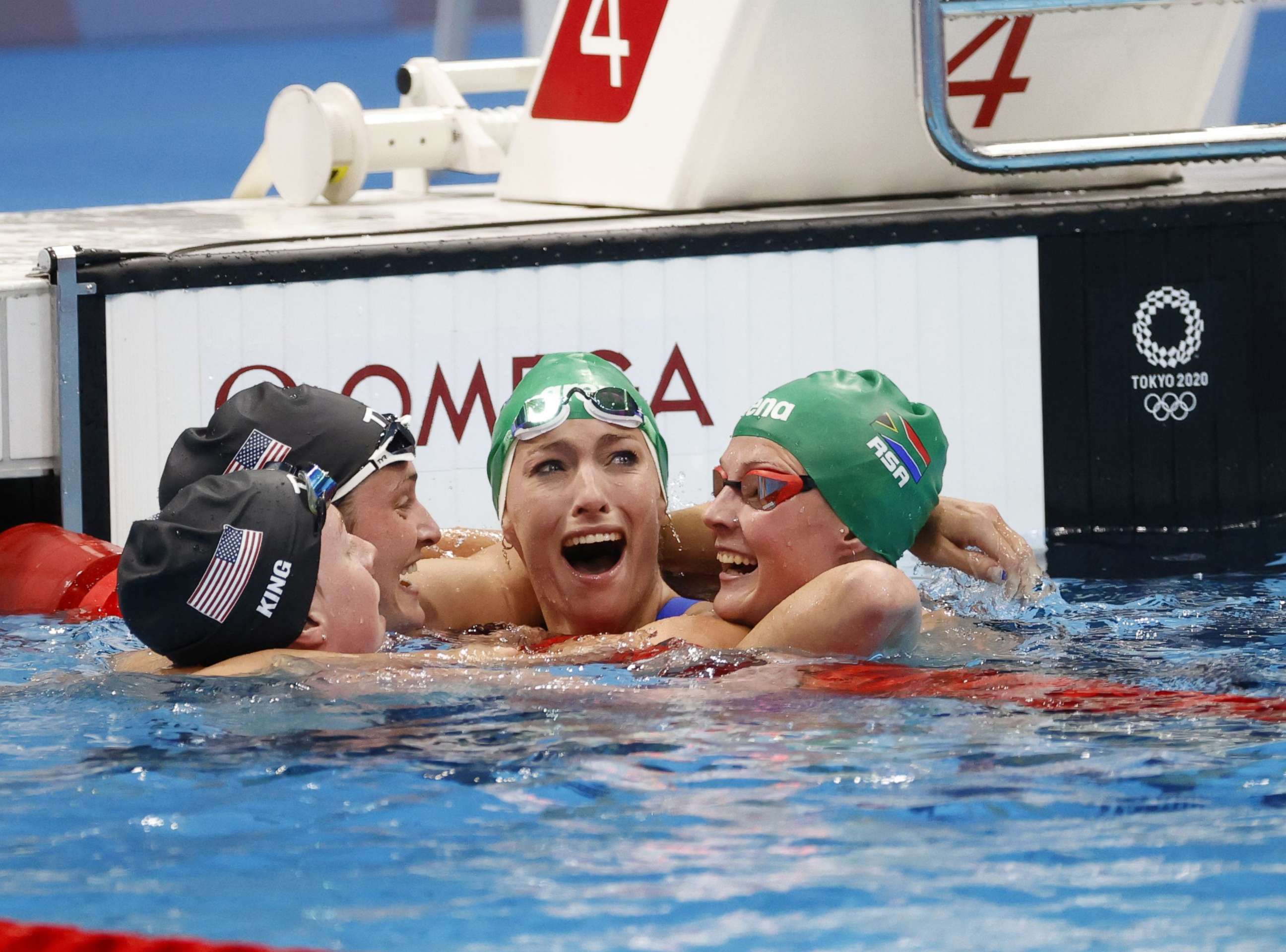 PHOTO: Tatjana Schoenmaker of South Africa reacts after her world record time in the women's 200m breastroke Final as she is congratulated by Lilly King, Annie Lazor, and Kaylene Corbett in Tokyo, Japan, July 30, 2021.