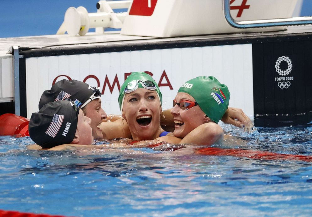 PHOTO: Tatjana Schoenmaker of South Africa reacts after her world record time in the women's 200m breastroke Final as she is congratulated by Lilly King, Annie Lazor, and Kaylene Corbett in Tokyo, Japan, July 30, 2021.