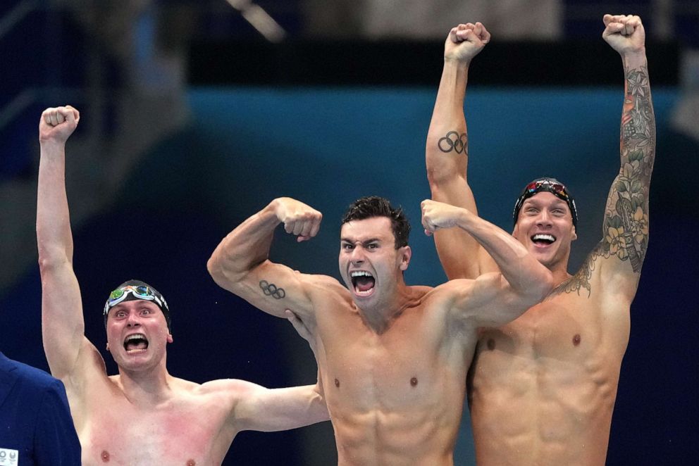 PHOTO: United States men's 4x100m freestyle relay team Bowen Beck, Blake Pieroni, and Caeleb Dressel celebrate after winning the gold medal at the 2020 Summer Olympics, Monday, July 26, 2021, in Tokyo, Japan.