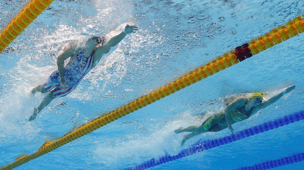 PHOTO: Katie Ledecky of the United States and Ariarne Titmus of Australia compete in teh Women's 400m freestyle on July 26, 2021 in Tokyo.