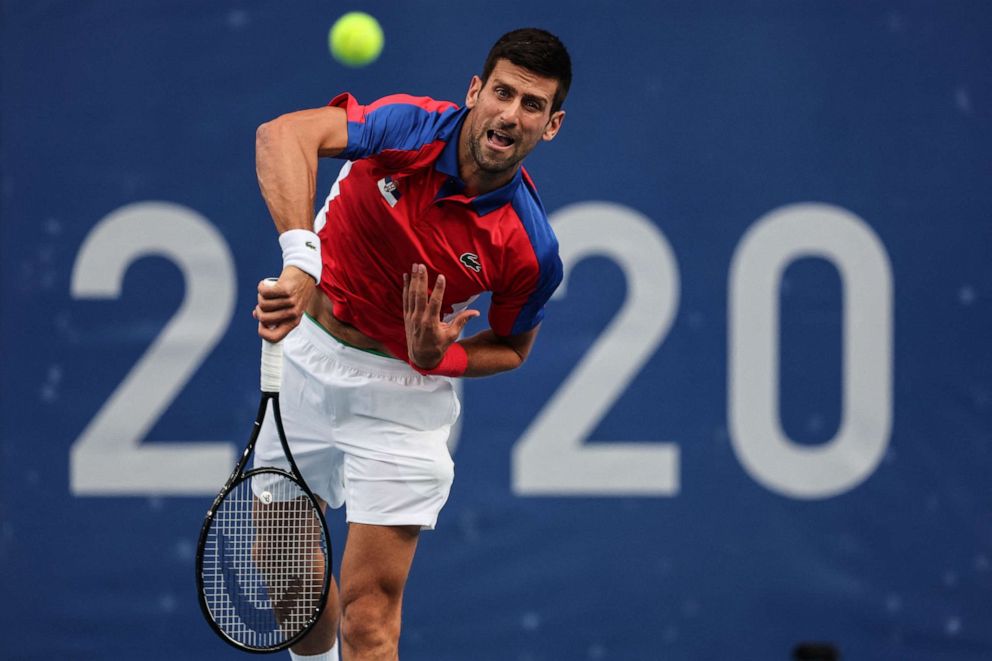 PHOTO: Serbia's Novak Djokovic serves to Germany's Jan-Lennard Struff during their Tokyo 2020 Olympic Games men's singles second round tennis match at the Ariake Tennis Park in Tokyo on July 26, 2021.
