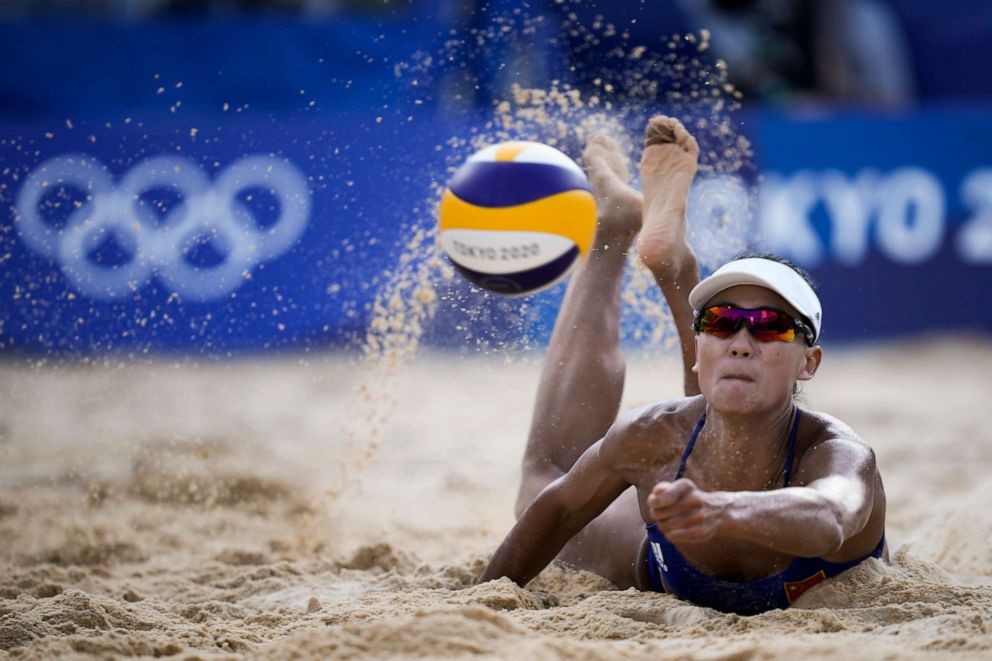 PHOTO: Xue Chen, of China, dives for the ball during a women's beach volleyball match against the Netherlands at the 2020 Summer Olympics, Tuesday, July 27, 2021, in Tokyo, Japan.