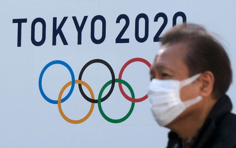 PHOTO: A pedestrian walks past the logo of the Tokyo 2020 Olympic Games in Tokyo on Feb. 4, 2021.
