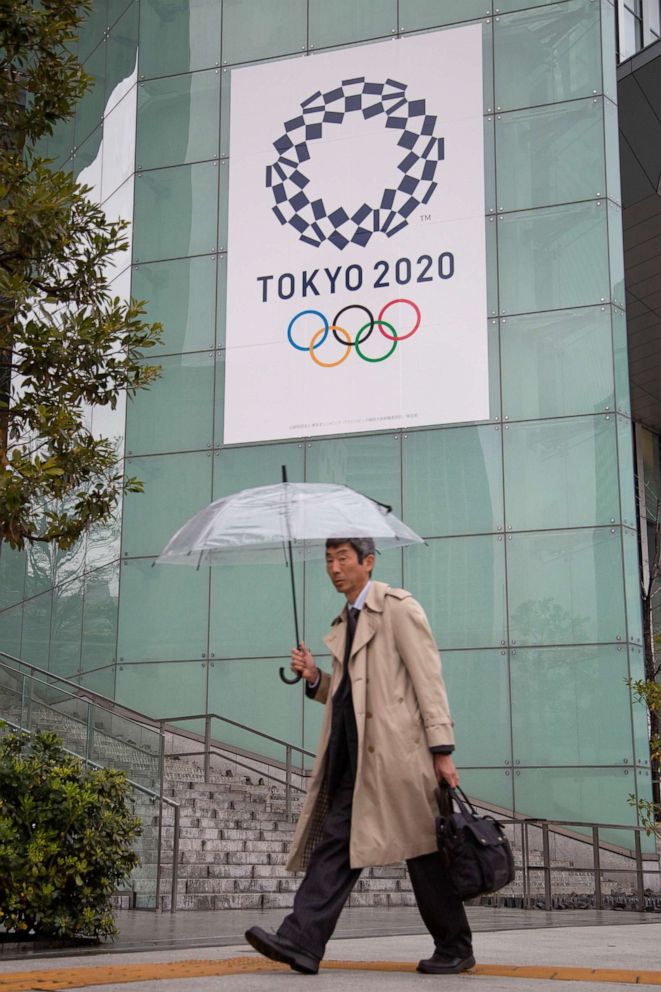 PHOTO: A man walks by the headquarters for the Tokyo Organizing Committee of the Olympic and Paralympic Games in Tokyo, Japan, on March 2, 2020.