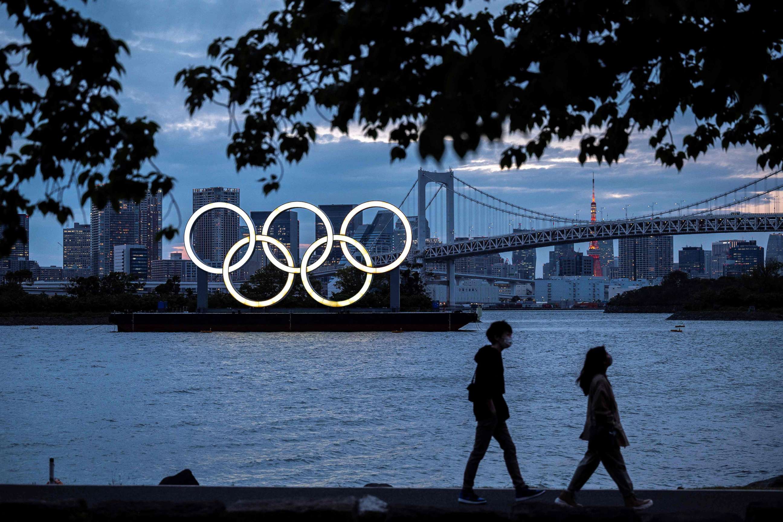 PHOTO: The Olympic rings lit up at dusk on the Odaiba waterfront in Tokyo on April 28, 2021.