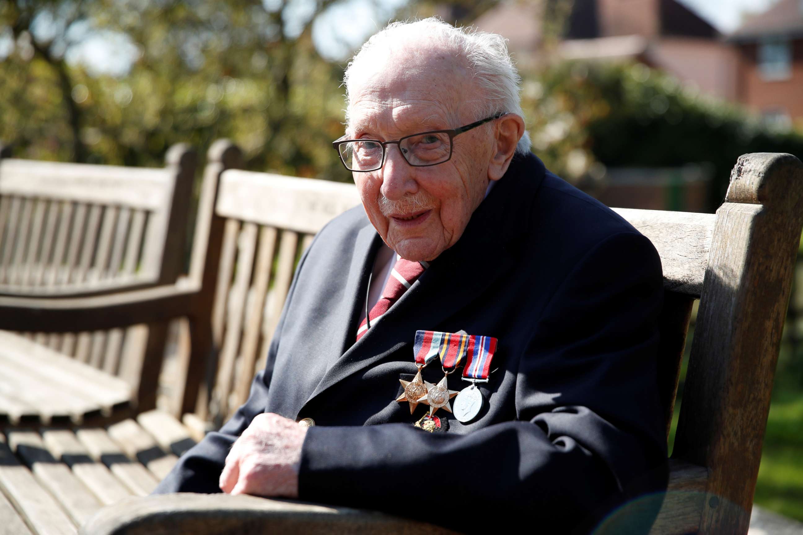 PHOTO: Retired British Army Captain Tom Moore, 99, raises money for health workers by attempting to walk the length of his garden one hundred times before his 100th birthday this month in Marston Moretaine, Britain, April 15, 2020.