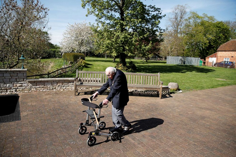 PHOTO: Retired British Army Captain Tom Moore, 99, raises money for health workers by attempting to walk the length of his garden one hundred times before his 100th birthday this month in Marston Moretaine, Britain, April 15, 2020.
