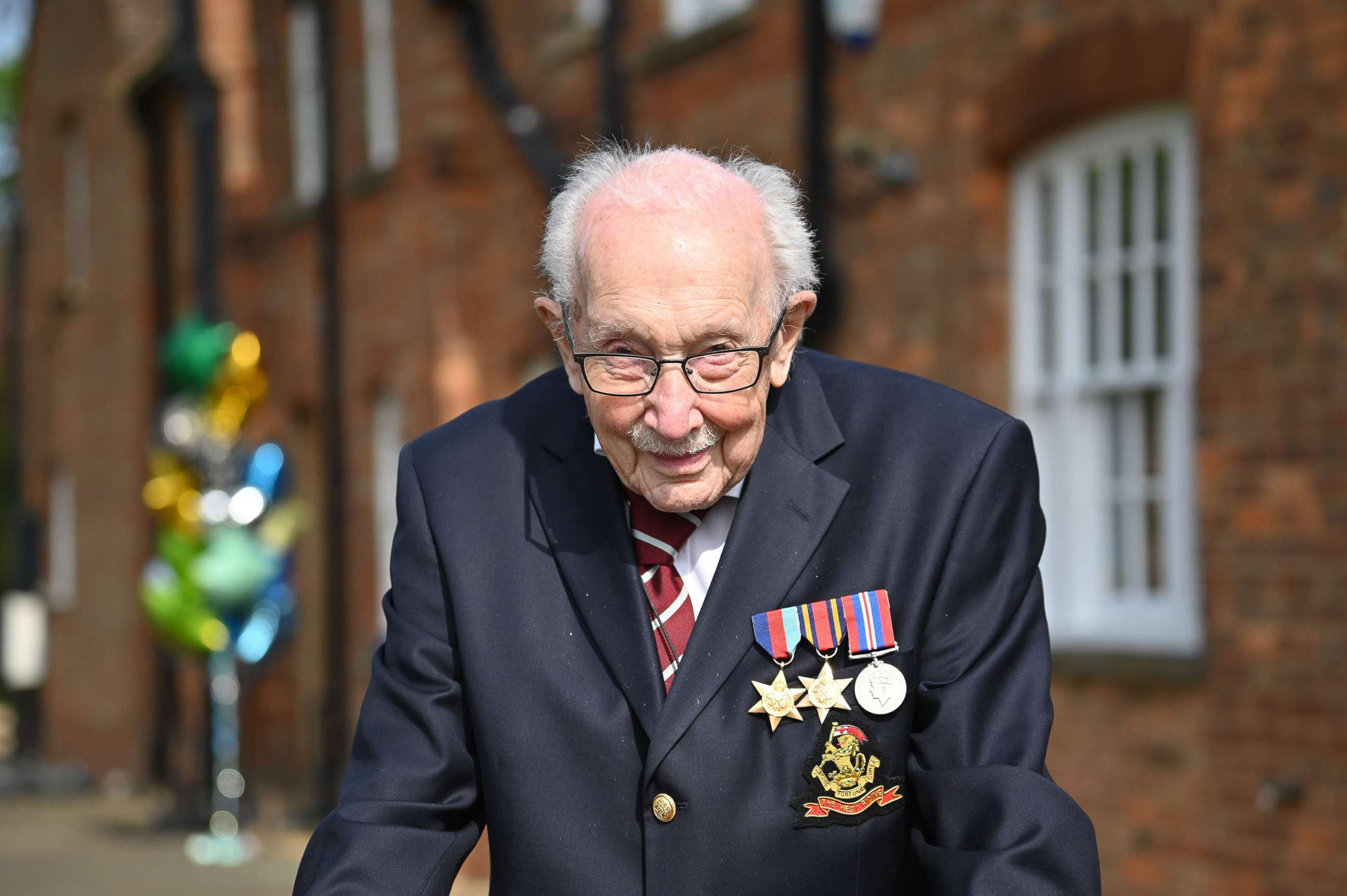 PHOTO: British World War II veteran Captain Tom Moore poses doing a lap of his garden in the village of Marston Moretaine, 50 miles north of London, April 16, 2020.