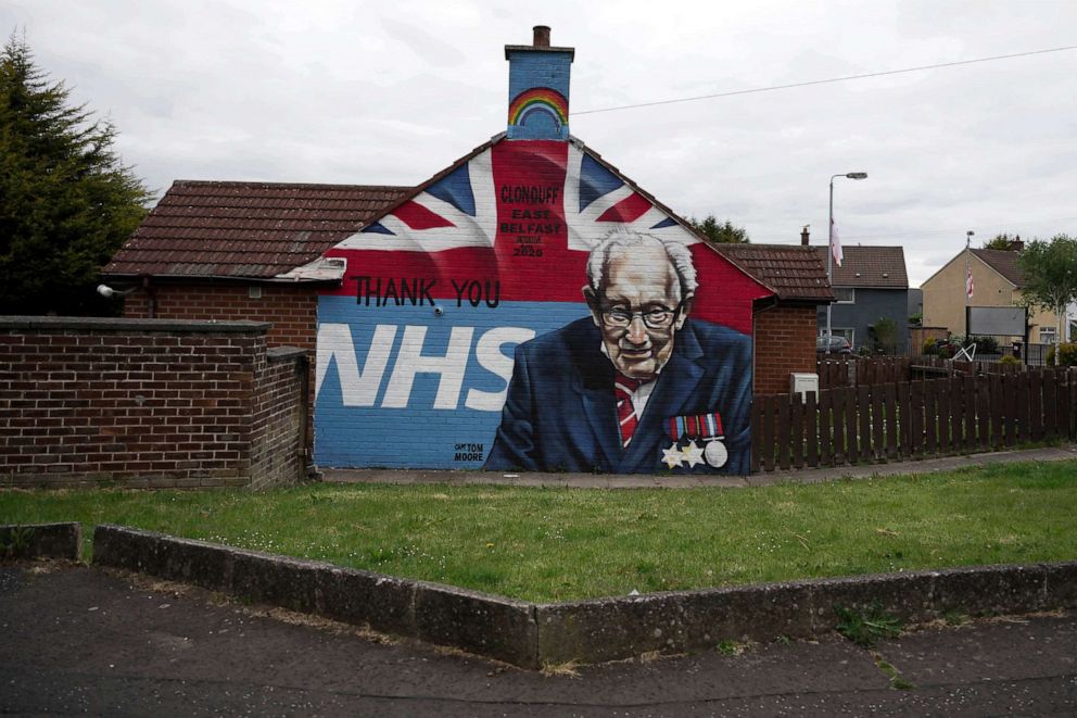 PHOTO: A mural depicting 100 year old army veteran and NHS fund raiser Captain Tom Moore can be seen in a loyalist housing estate, May 18, 2020, in Belfast, Northern Ireland.