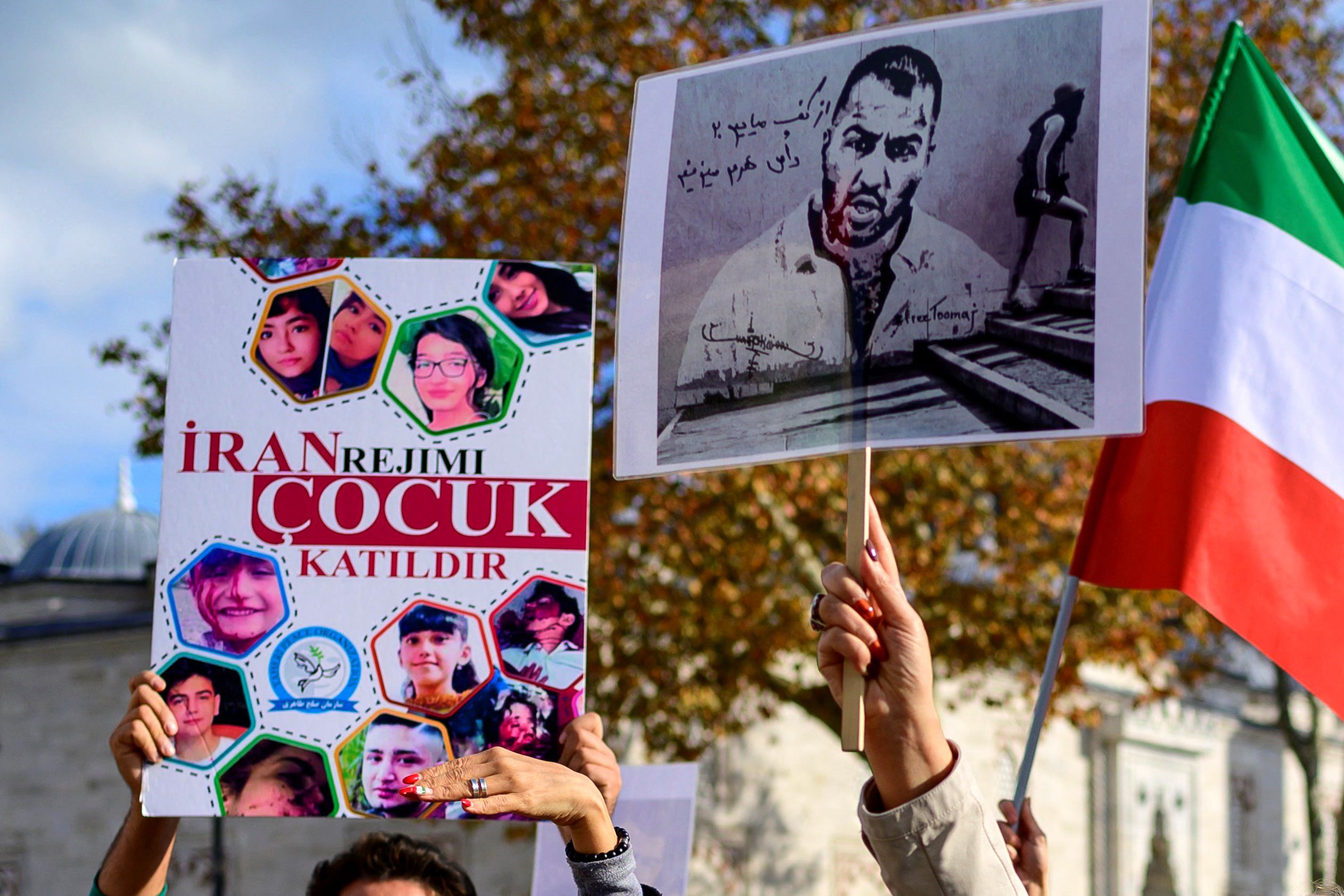 PHOTO: People hold signs bearing portraits of Iranian rapper Toomaj Salehi, right, arrested in Iran, and portraits of children killed during the protests during a rally in support of Iranian women in Istanbul, Nov. 26, 2022.