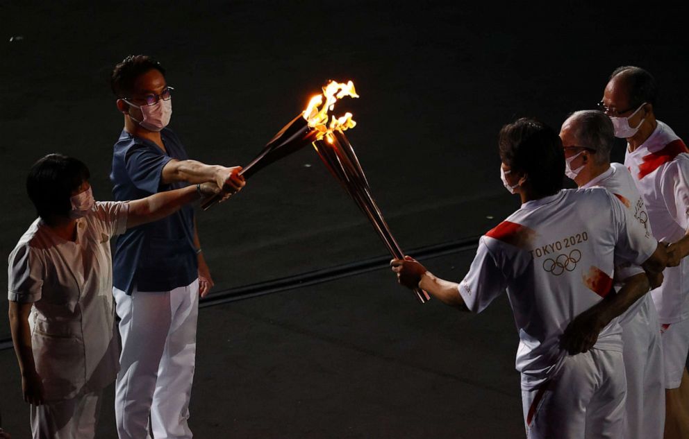 PHOTO: The Olympic torch is carried during the opening ceremony in Tokyo, July 23, 2021.