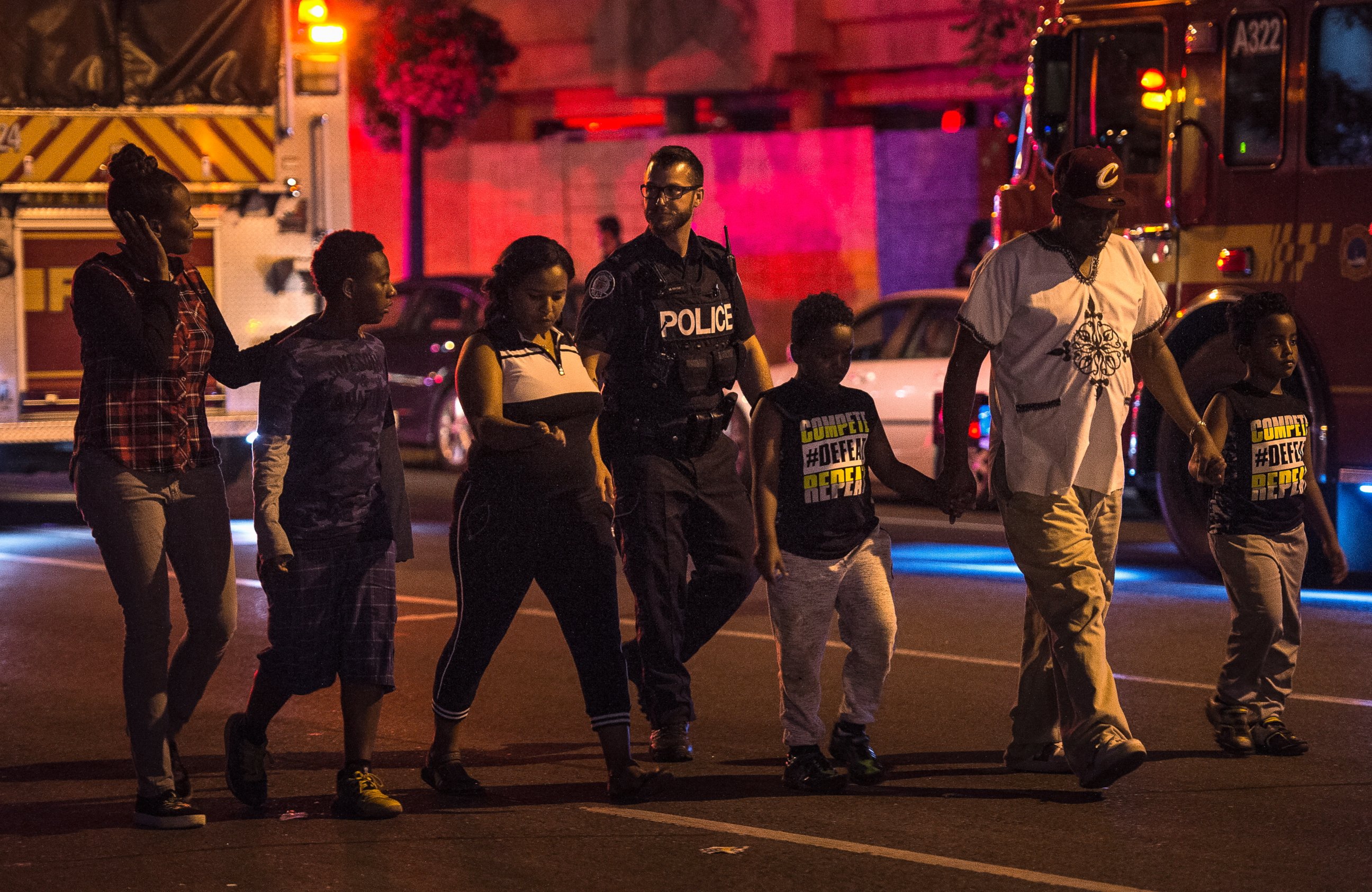 Police escort civilians away from the scene of a shooting, Sunday, July 22, 2018, in Toronto. 