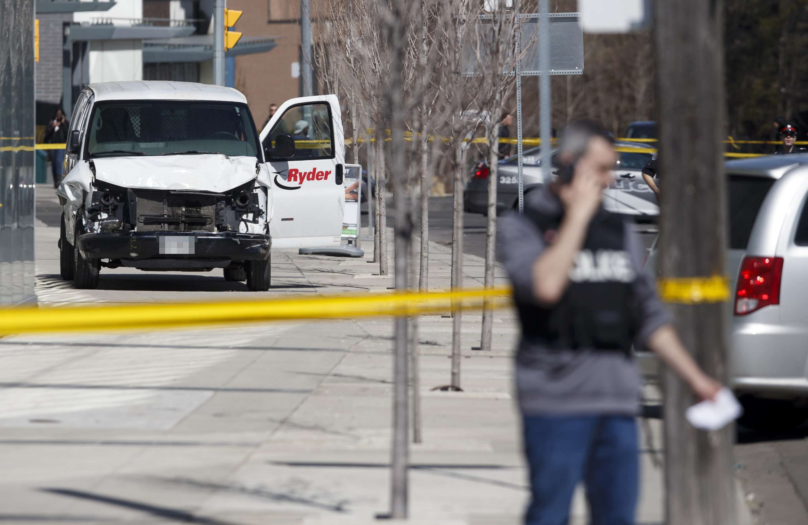 PHOTO: Police inspect a van suspected of being involved in a collision injuring at least eight people at Yonge St. and Finch Ave., April 23, 2018, in Toronto, Canada.