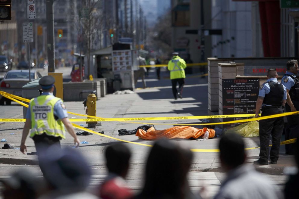 PHOTO: A tarp lays on top of a body on Yonge St. at Finch Ave. after a van plowed into pedestrians, April 23, 2018, in Toronto, Canada.