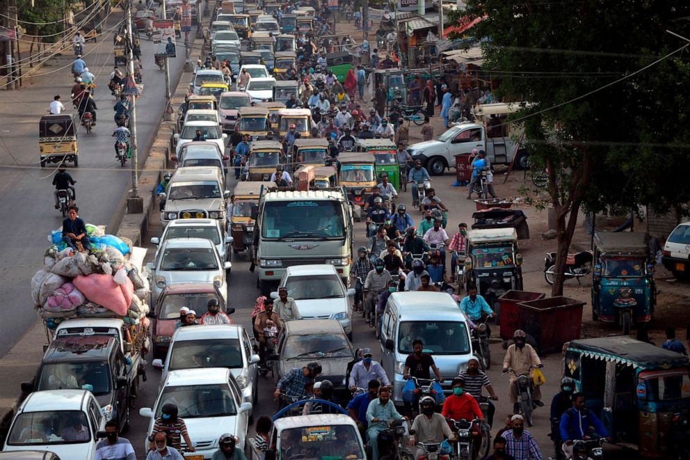PHOTO: Commuters make their way along a street in Karachi, Pakistan, on May 12, 2020, after the government eased a nationwide lockdown imposed to curb the spread of the novel coronavirus.