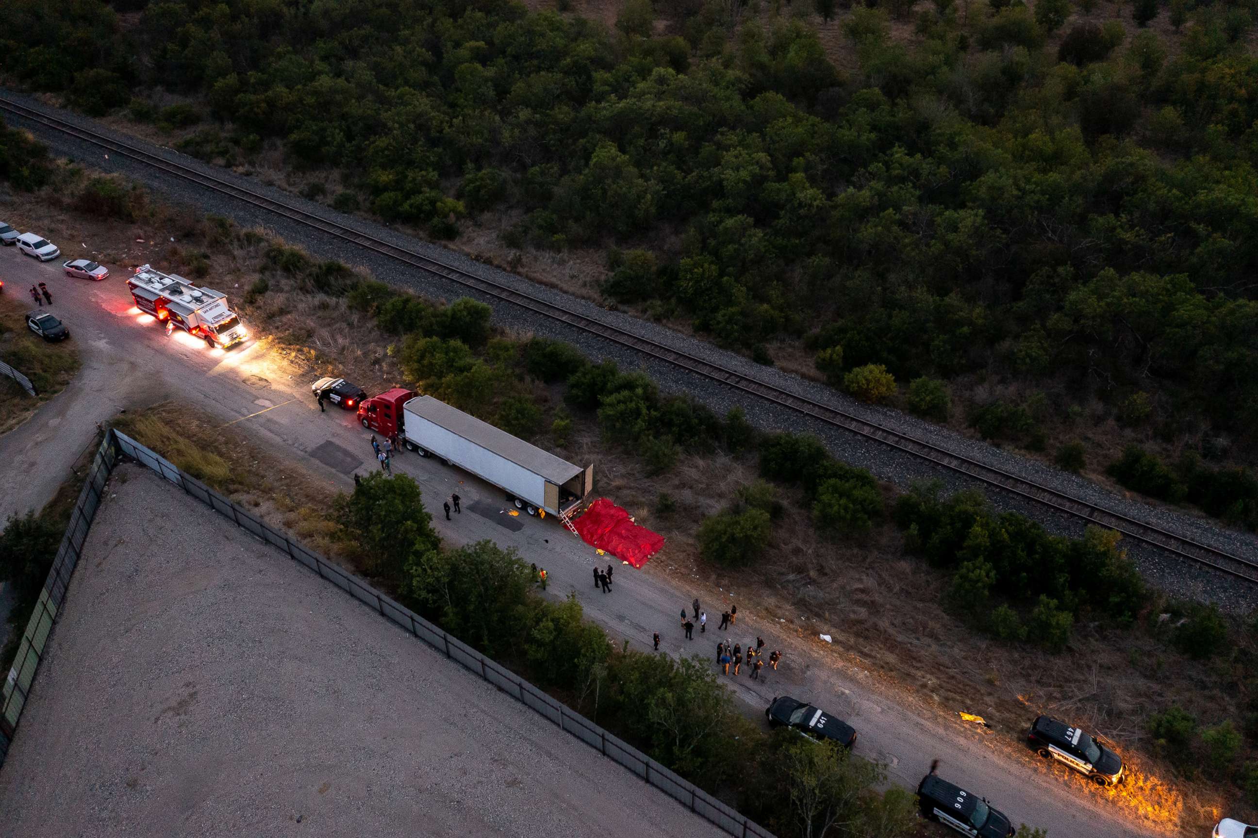 PHOTO: Members of law enforcement investigate a tractor trailer, June 27, 2022, in San Antonio, Texas, where at least 46 people, were found dead.
